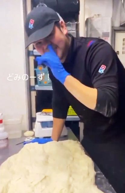 worker-picks-nose-wipes-pizza-879343280