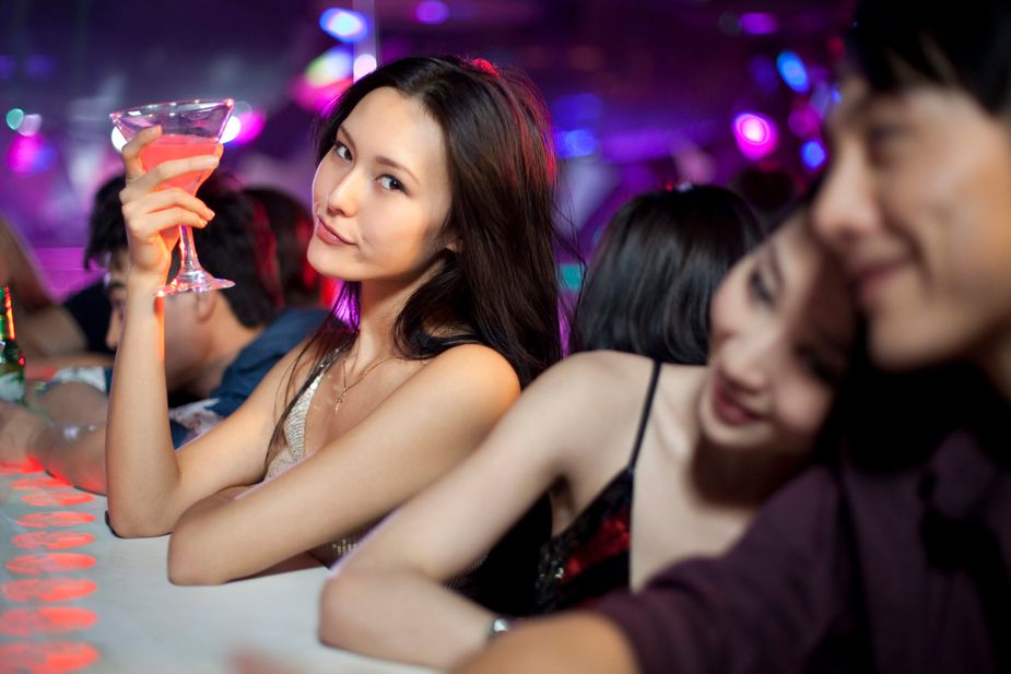 Stylish young Chinese at bar counter