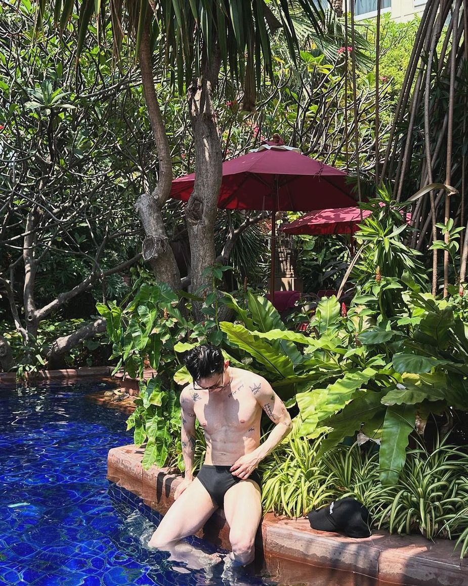 Jo Kwon posing in swimsuit by pool