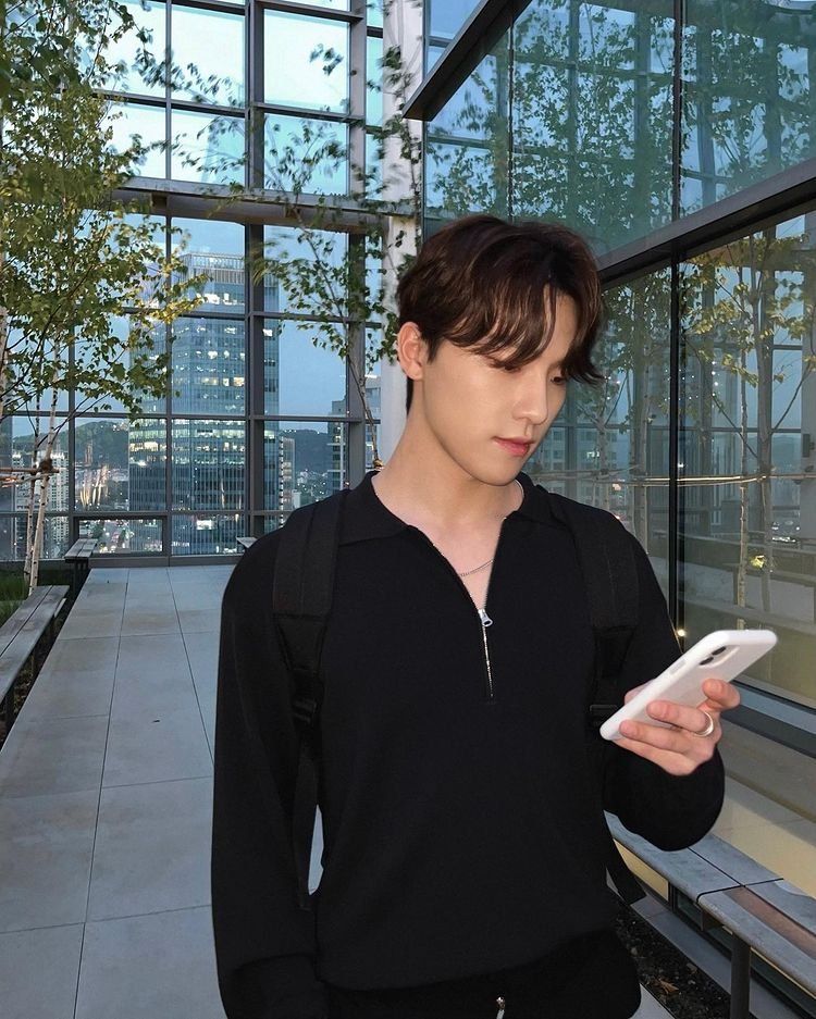 SEVENTEEN's Dino looking at his mobile phone